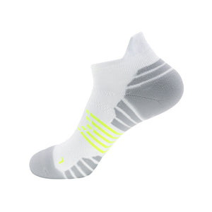 White ankle sock with grey ventilation zones and neon yellow accents.
