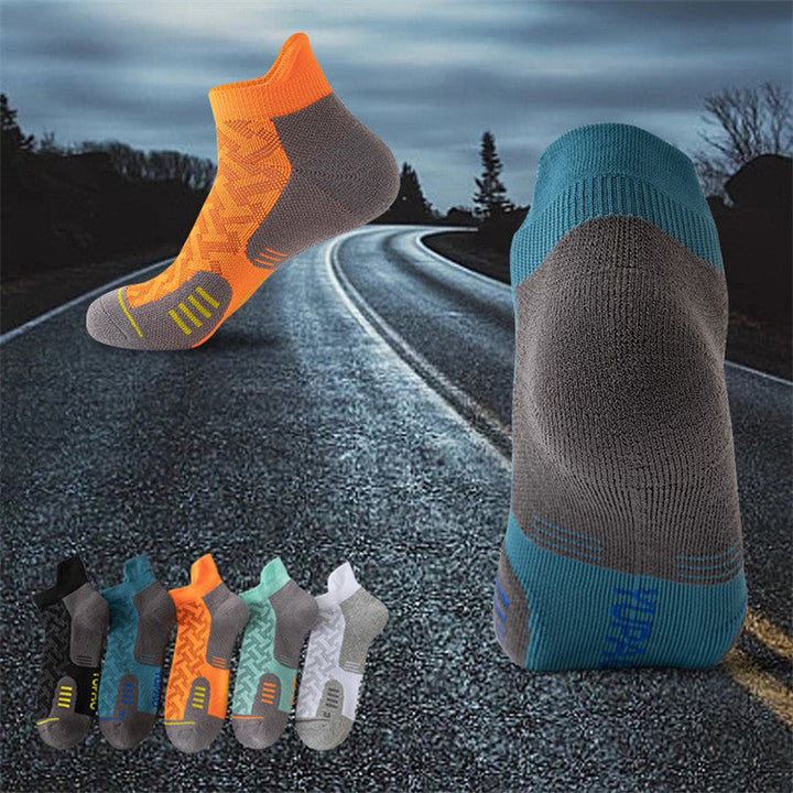 Assortment of athletic ankle socks in various colors displayed on a road background, symbolizing active lifestyle and motion.