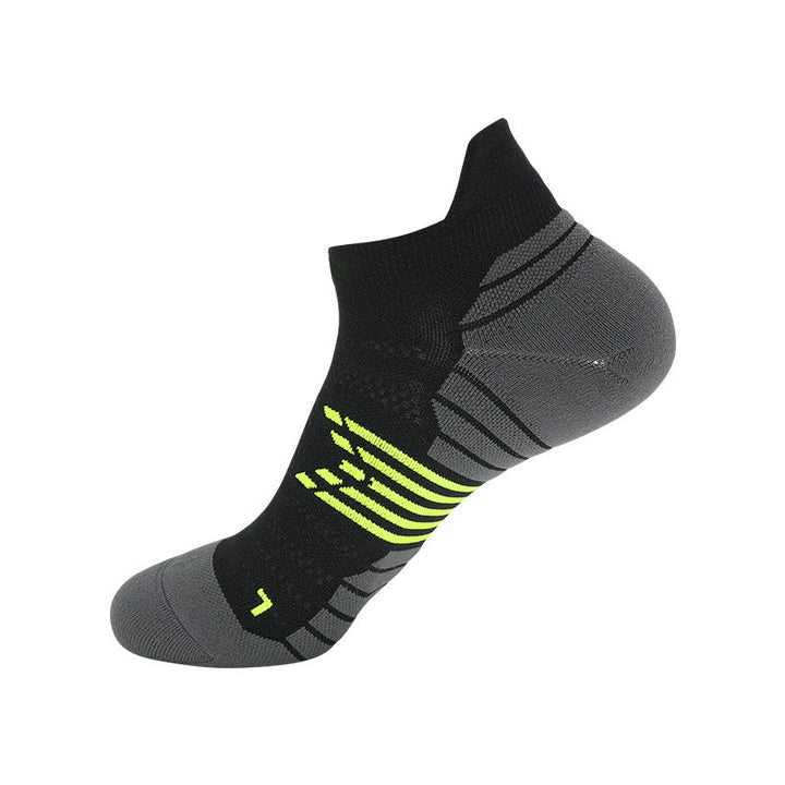 Black ankle sock with grey ventilation zones and neon green accents.