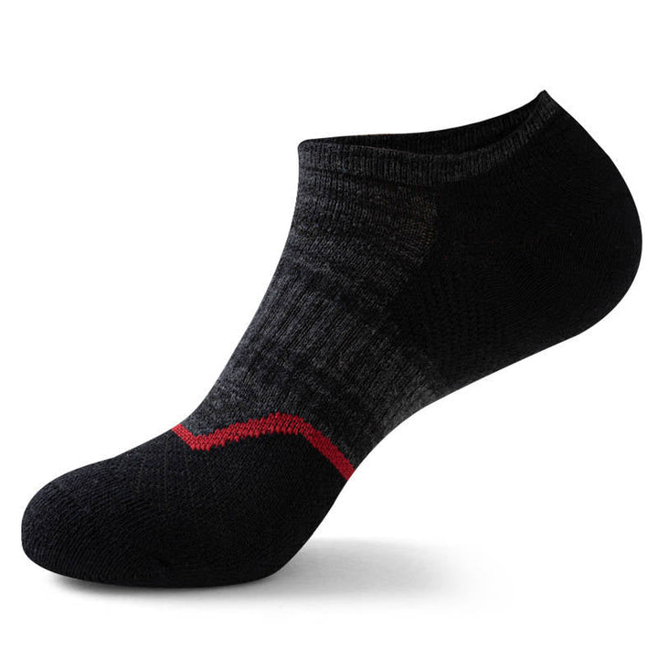 Single black ankle sock with a distinctive red stripe on the arch, isolated on a white background.