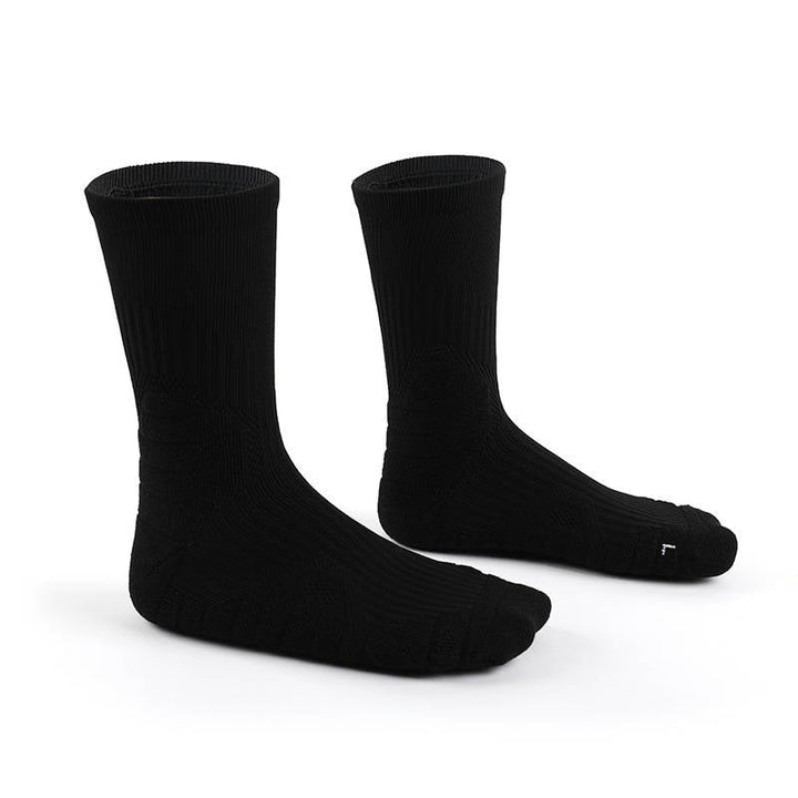 A pair of black knit socks on a white background.