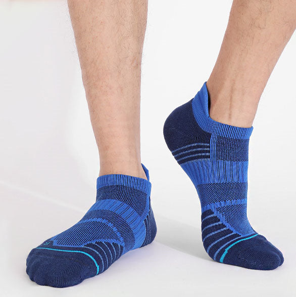 Man wearing blue basketball socks with darker blue and turquoise stripes.