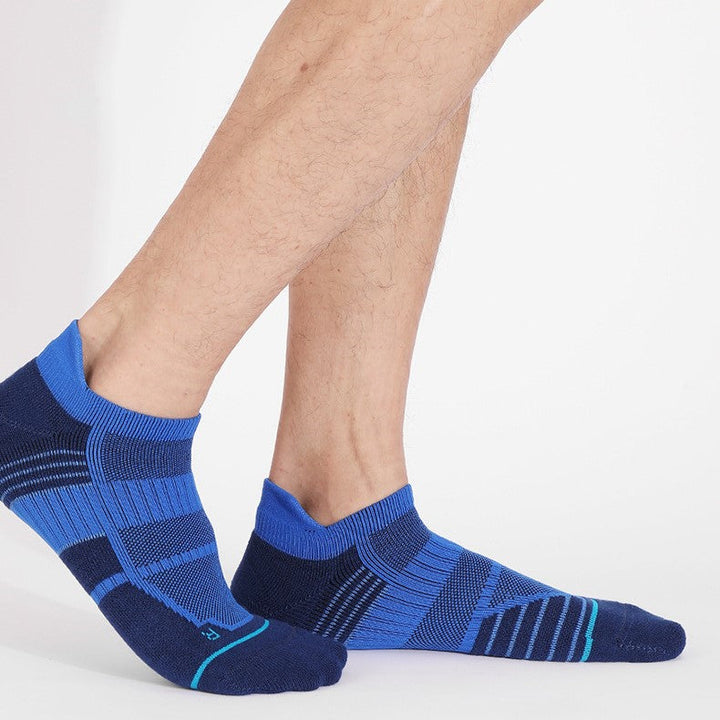 Man wearing blue and dark blue basketball socks with teal accents.