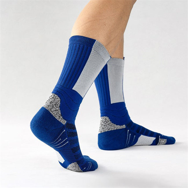 Person standing on tiptoes wearing blue and grey basketball socks with enhanced padding and arch support.