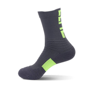 Charcoal grey athletic sock with neon green stripes on the back and cushioning on the sole.