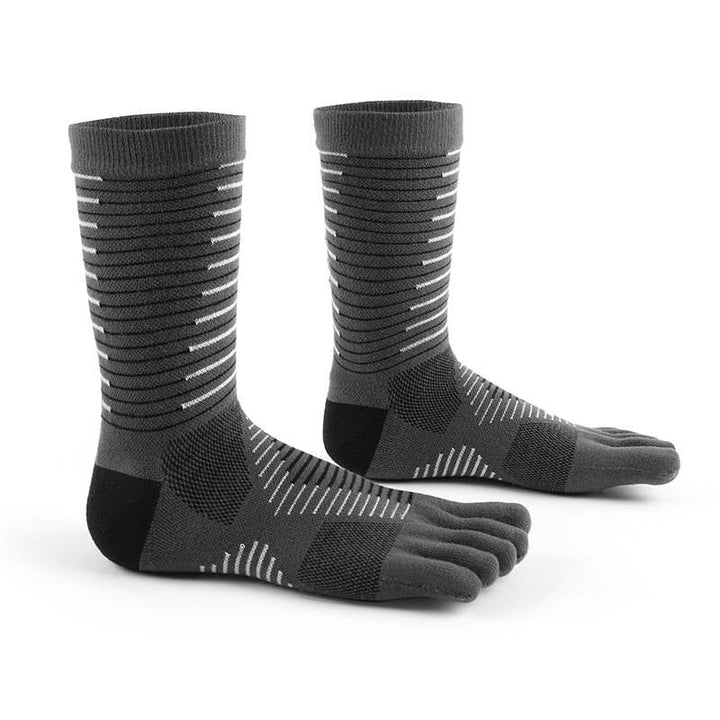 Pair of grey five-toe performance socks with black grip patterns, standing on a white surface.