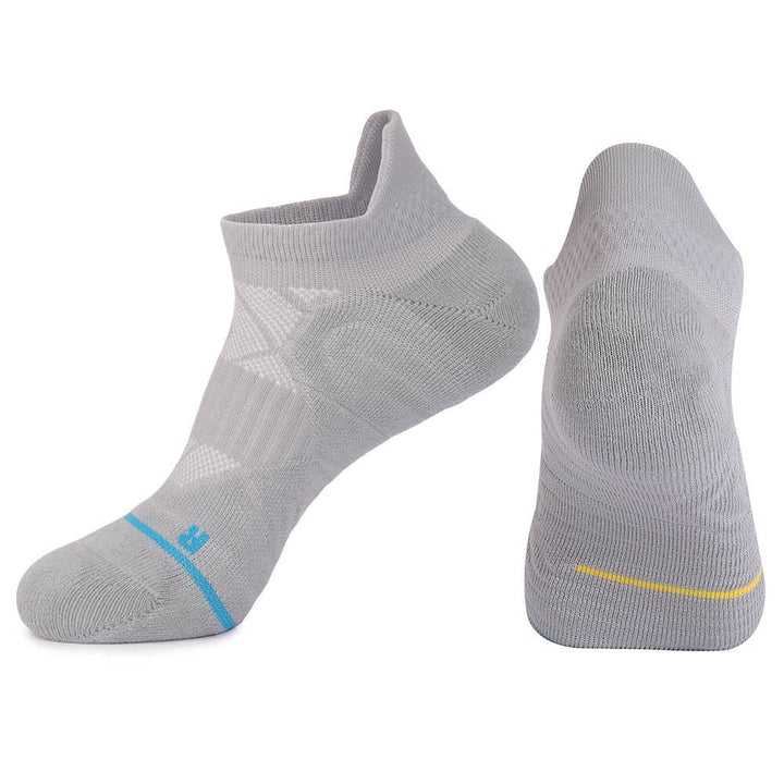 Two grey sports socks with light blue and yellow accents, one viewed from the side and the other from the bottom.