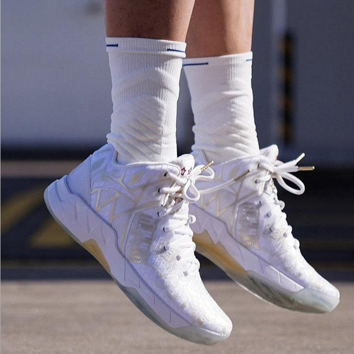 Person mid-jump wearing white high-top basketball sneakers and crew socks with blue stripes.