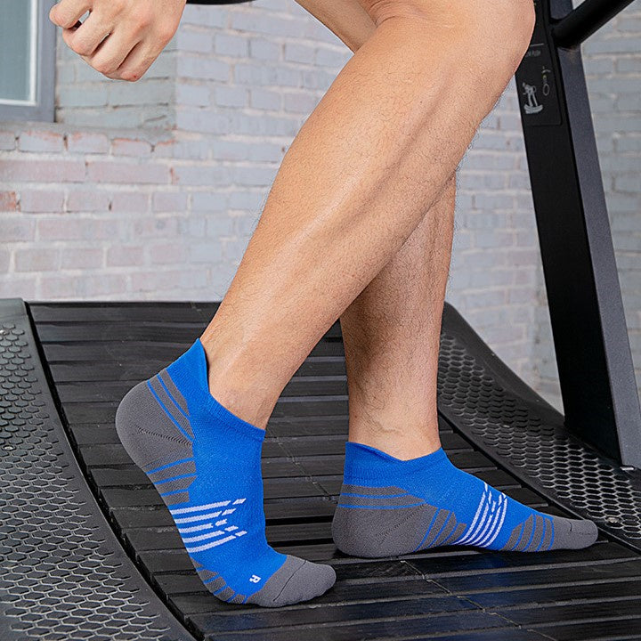 Man wearing blue and grey ankle socks on a treadmill.