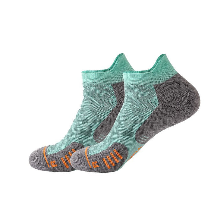 Mint green ankle socks with grey cushioning and orange details.