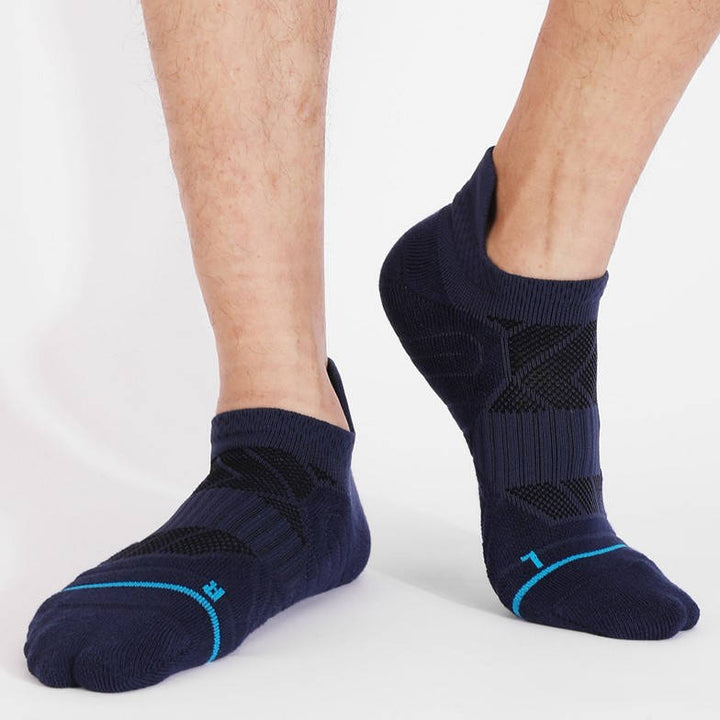 Person wearing navy blue athletic socks with light blue trim, standing upright.