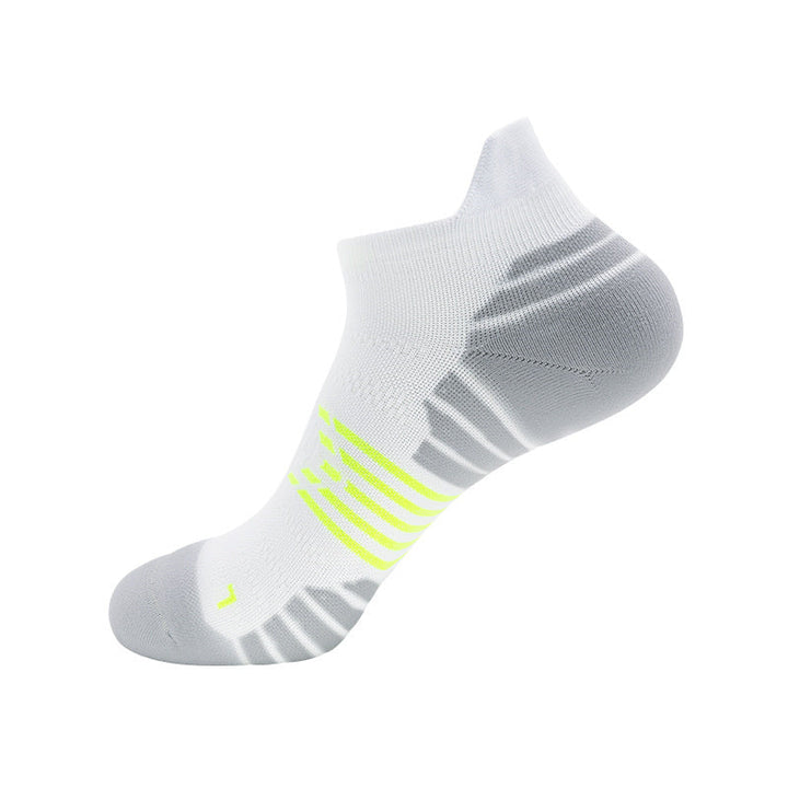 White ankle sock with grey ventilation zones and neon yellow accents.