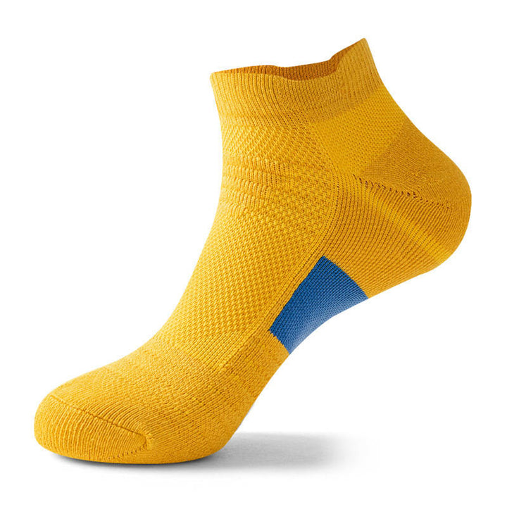 Yellow ankle sock with a white patch on the foot arch, isolated on a white background.