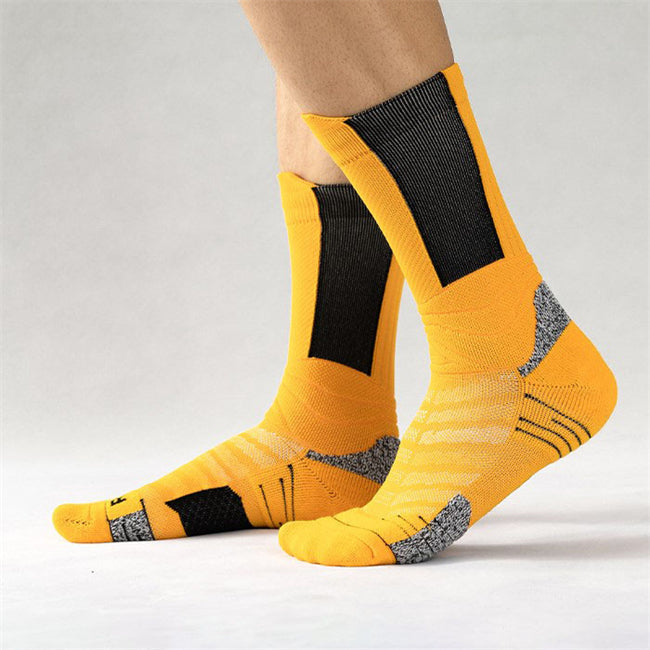 Person wearing yellow and black basketball socks with mesh panels for breathability and cushioned areas for support.